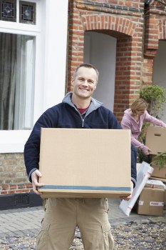 Professional movers loading furniture into a van