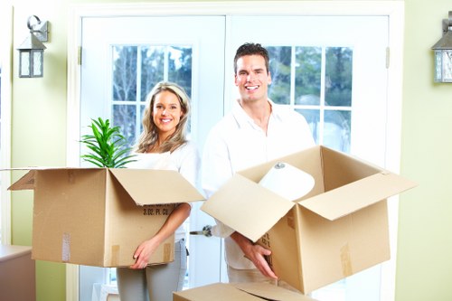 Professional movers handling sensitive office equipment